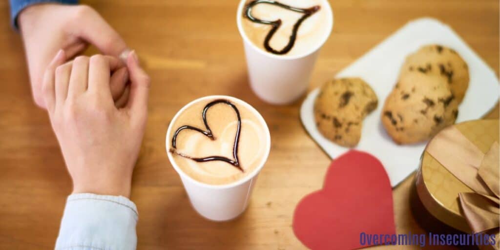 Two people holding hands, with two coffee cups topped with heart shapes, a paper heart, and some biscuits next to them create a warm and cozy scene perfect for sharing love and connection. This image captures the essence of togetherness, affection, and enjoying simple moments with loved ones. The combination of coffee, hearts, and biscuits evokes feelings of comfort, happiness, and romance. It's a beautiful visual representation of bonding over shared experiences and creating lasting memories together.
