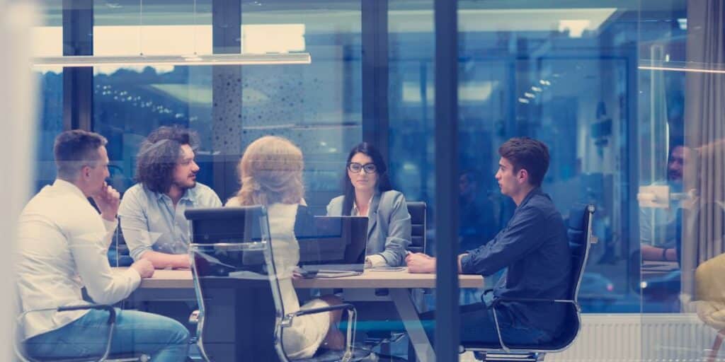 Leader discussing goals with their team in a meeting