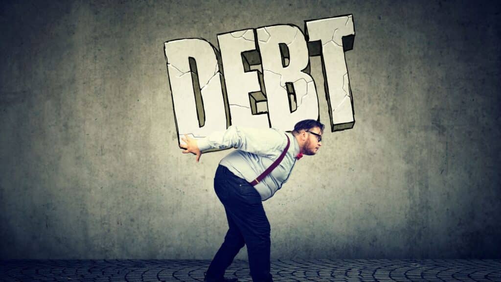 Avoid Accumulating More Debt. man carrying a debt big words on is back