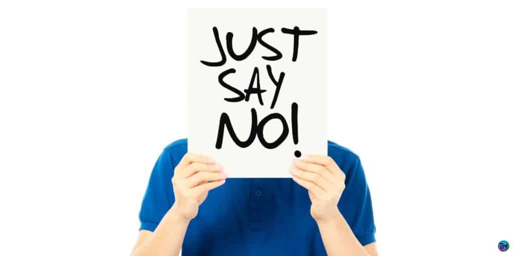 a person holding a sign that says just say no.