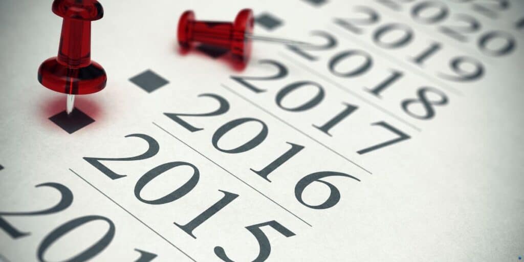 a red push pin is placed on top of a calendar